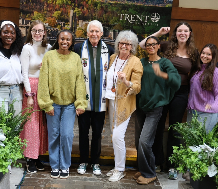 Trent students celebrate Stephen Stohn and Linda Schuyler (middle) for their contributions to student supports and well-being at an event at the Symons Campus.