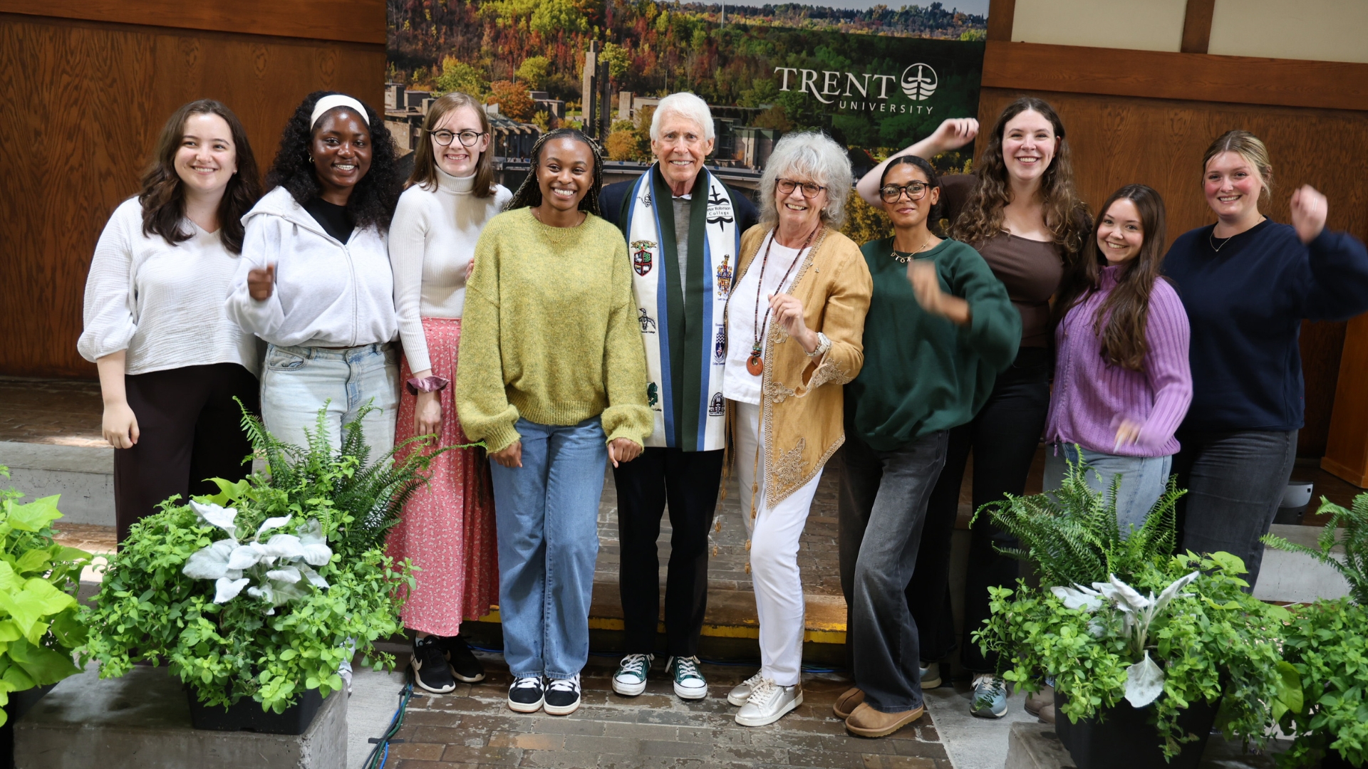 Trent students celebrate Stephen Stohn and Linda Schuyler (middle) for their contributions to student supports and well-being at an event at the Symons Campus.