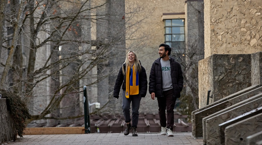 Two individuals walking on campus