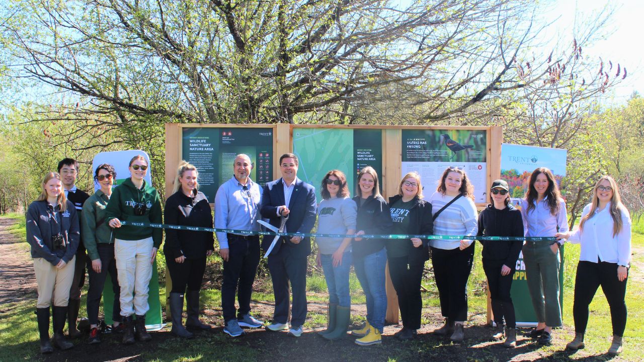 An image of Trent community members cutting the ribbon
