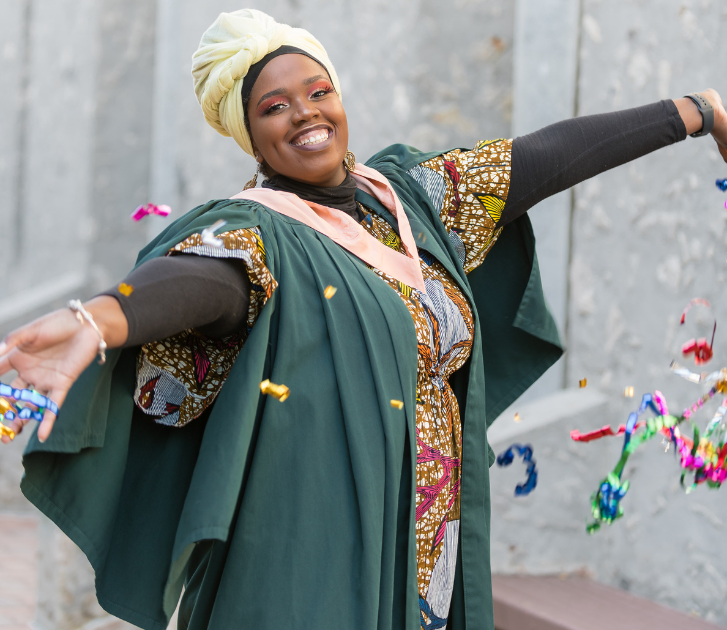 An image of a graduate student in a green gown